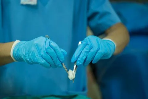 A nurse is preparing a tool to dressing the patient's wound. Stock Photos
