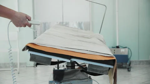 Nurse pressing buttons on remote control, surgical operating table rotating 스톡 동영상 201729566