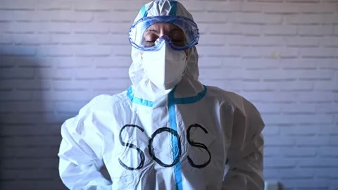 Nurse in protective suit and work clothes looking at camera Stock-Footage 145328112