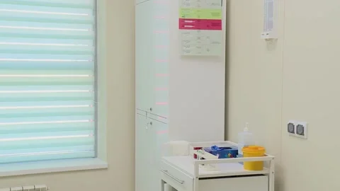 Nurse in a protective suit approaches the table to take the sample tests Stock Footage 132318583