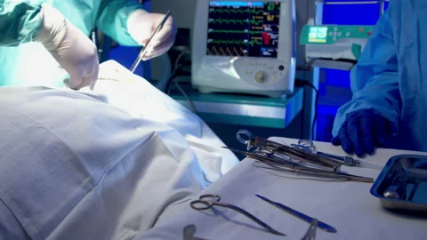 Nurse providing surgeon with tools during surgery Stock Footage 140756154