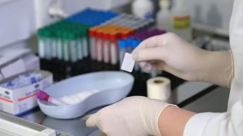 Nurse puts a bar code on a test tube Stock Footage 83561481