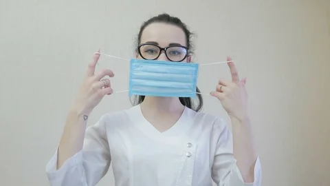 A nurse puts on a face shield. The epidemic situation. Coronavirus or COVID19. Stock Footage 126892907