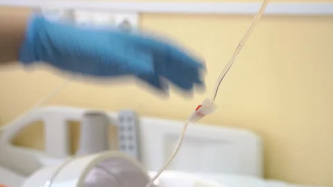 Nurse putting a drip into the catheter lying patients close-up.Injection vaccine Stock Footage 96603537