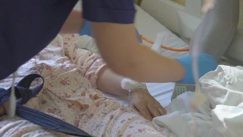 Nurse putting a drip into the catheter lying patients close-up.Injection vaccine Stock Footage 96607182