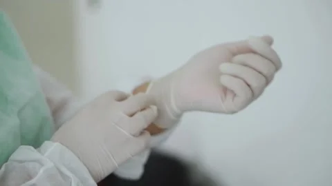 Nurse putting on gloves Stock Footage 153344137