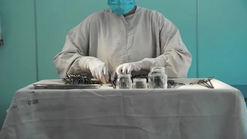 Nurse putting surgical instruments on table, preparing tools for operation Stock-Footage 201483860