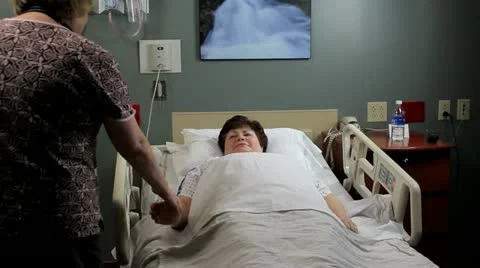 Nurse raising patients hospital bed Stock Footage