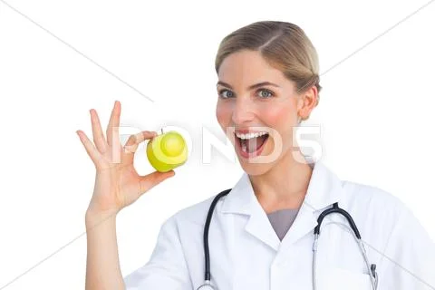 Nurse ready to eat apple Stock Photos