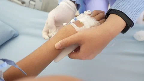 The nurse remove the saline lock from kid's hand in the hospital Stockbeeldmateriaal 101930502