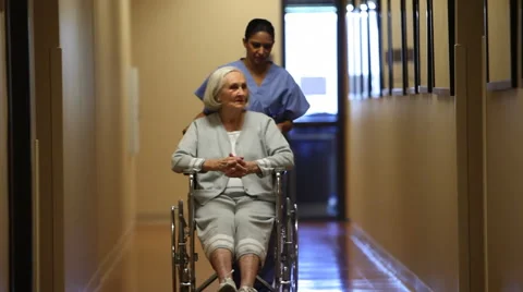 Nurse rolling patient in corridor Stock-Footage 61674587