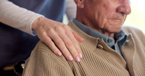 Nurse, senior and hands with shoulder in wheelchair for assisted living or Stock Footage 340609082