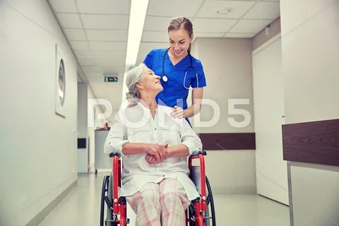 Nurse with senior woman in wheelchair at hospital Stock Photos