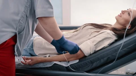 Nurse is setting up needle and IV stand Stock Footage 255883282