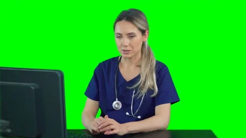 Nurse sitting in front of computer talking to patient. Telemedicine video chat Stock Footage 132005202