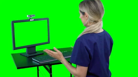 Nurse sitting in front of computer talking to patient. Telemedicine video chat Stock Footage 132010325