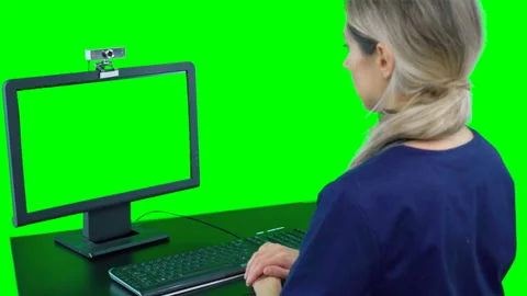 Nurse sitting in front of computer talking to patient. Telemedicine video chat Stock Footage 132011675