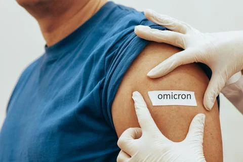 Nurse sticks patch on man after vaccination. The concept of worldwide Stock Photos