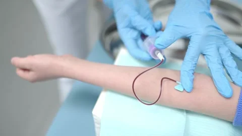 A nurse takes blood from a child using butterfly needle Stock Footage 289639603