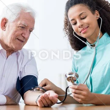 Nurse taking blood pressure Stock Photos