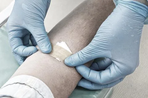 Nurse taking blood sample to make a test in laboratory. Blue tonning Stock Photos