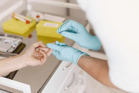 Nurse taking blood sample from patient at the doctors office Stock Photos