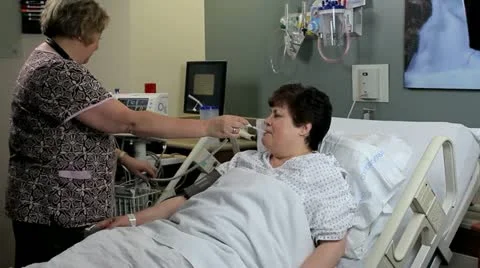 Nurse taking patients temperature Stockbeeldmateriaal 12508370