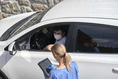 Nurse taking a young driver's data before vaccination Stock Photos