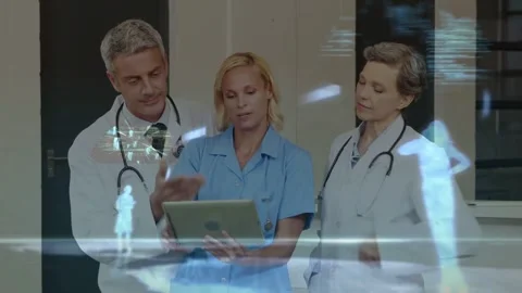Nurse tapping tablet causing hologram data rising while angling pad, doctors Stock Footage 333965598