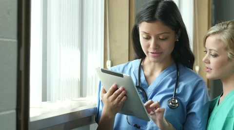 A Nurse team looking at an ipad/tablet, close up Stock Footage 53125224