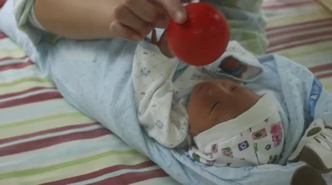 Nurse testing the visual activity of a newborn baby after taking a bath Stock Footage 55256384