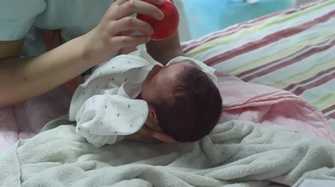 Nurse testing the visual activity of an one day old newborn baby Stock Footage 55342869