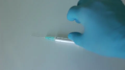 Nurse throwing a syringe after using 스톡 동영상 65372456