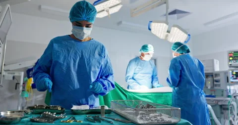 Nurse with tools, surgery and team in operating room at emergency healthcare Vídeo Stock 252678815
