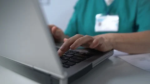 Nurse typing on laptop pc, completing medical documentation online, consultation Vidéo 119289807