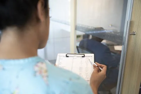 Nurse using checking list on clipboard in hospital 写真素材