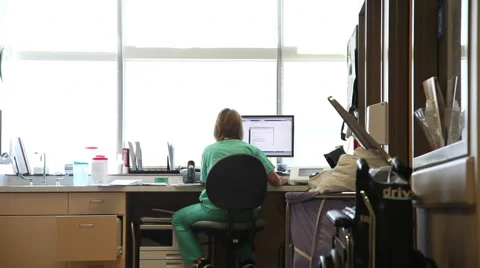 Nurse using computer, behind shot. Stock Footage