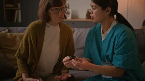 Nurse Using Glucometer on her Elderly Pa... | Stock Video | Pond5