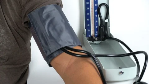 The nurse is using a manual sphygmomanometer to measure the blood pressure Stock Footage 105902027