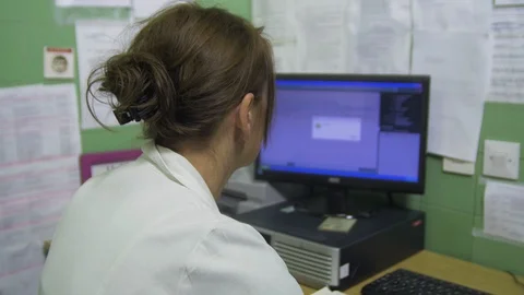 Nurse using mouse and keyboard to entering patient data in computer, tilt up. Stock Footage 86202804