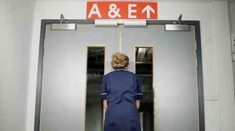 Nurse walks through hospital doors low angle  Stock Footage 59087306