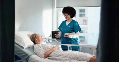 Nurse, women and discussion by hospital bed with tablet, report and good news Stock Footage 310498508