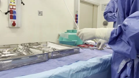 A nurse working with surgical instruments in an operating room Stock Footage 293762809