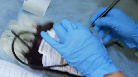 A nurse writes data on a blood bag sticker Stock Footage 103144915