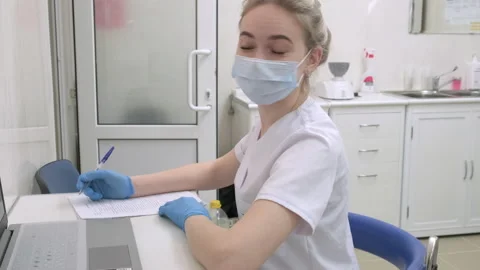 Nurse writes down information about the patient according to doctor Video stock 171058392