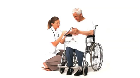 Nurse writing notes about her male patient Stock Footage 2168005