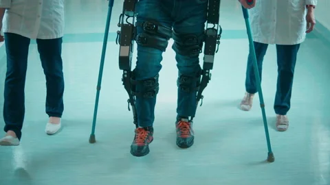 Nurses are helping a handicapped man to move in the exosuit Stock Footage 158153655