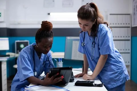 Nurses collegues working on tablet Stock Photos