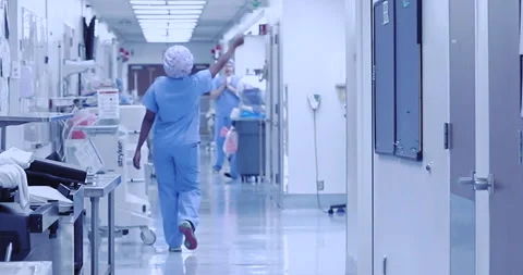 Nurses Doctors and Surgeons walking down hospital corridor in scrubs collection Stock Footage 145925598