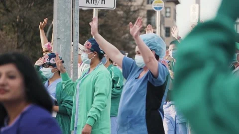 Nurses Doctors Waving in Scrubs During Covid-19 Coronavirus Pandemic Видео 135493015